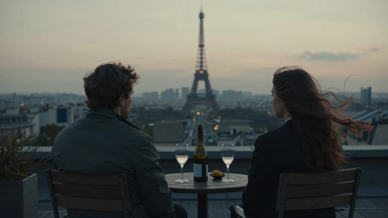 Two figures sit in silent companionship on a rooftop terrace as Paris sparkles in the distance.